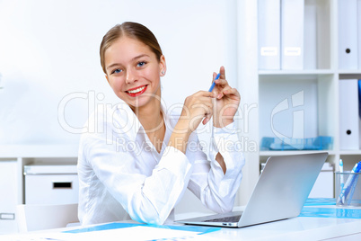 Young woman in business wear working in office