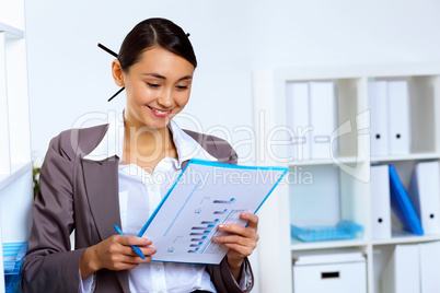 Young woman in business wear working in office