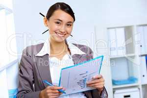 Young woman in business wear working in office