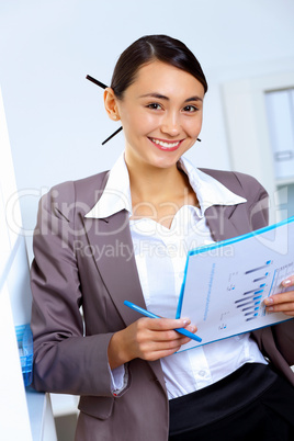 Young woman in business wear working in office