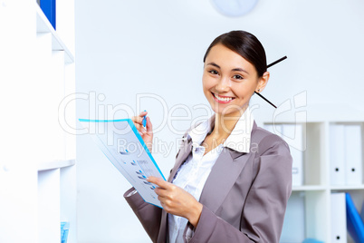 Young woman in business wear working in office