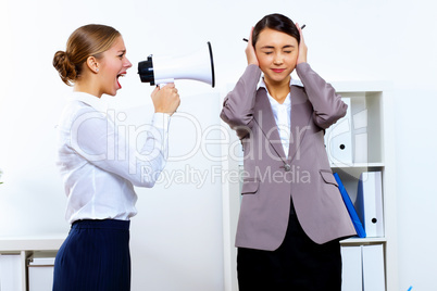 Young woman with megaphone in office