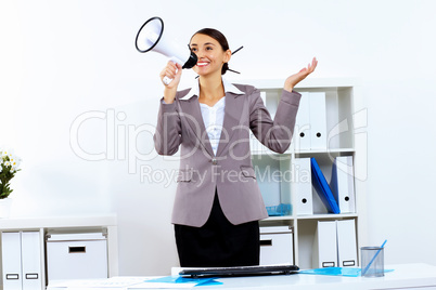 Young woman with megaphone in office