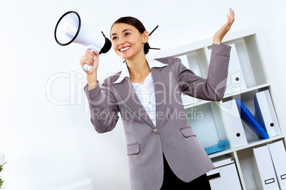 Young woman with megaphone in office