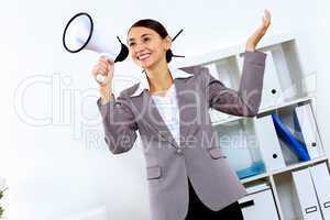 Young woman with megaphone in office