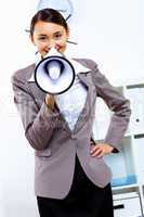 Young woman with megaphone in office