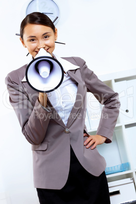 Young woman with megaphone in office