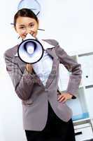 Young woman with megaphone in office