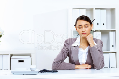 Young woman with a phone in office