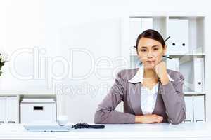 Young woman with a phone in office