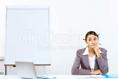 Young woman with a phone in office