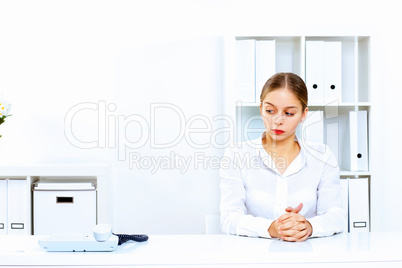 Young woman with a phone in office