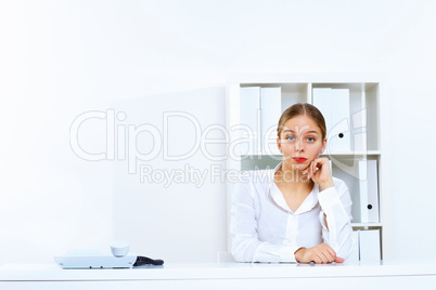 Young woman with a phone in office