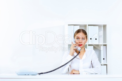 Young woman with a phone in office