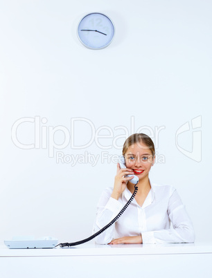 Young woman with a phone in office