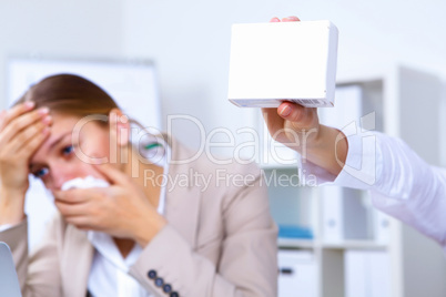 Woman in office holding a pack of medicine