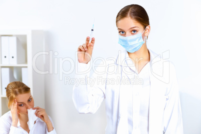 Nurse with syringe doing vaccination in office