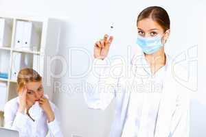 Nurse with syringe doing vaccination in office