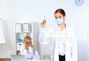 Nurse with syringe doing vaccination in office