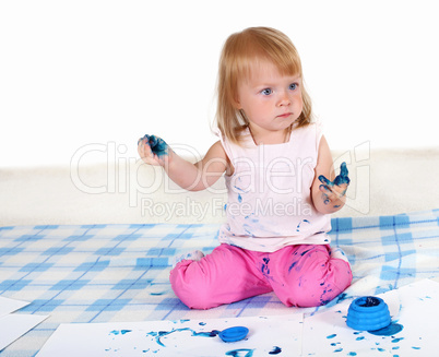 Little girl painting in studio