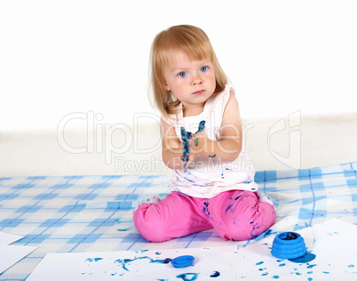 Little girl painting in studio