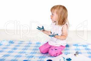 Little girl painting in studio