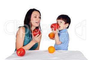 Mom and her young son together eat fruits