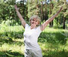 An elderly woman practices yoga