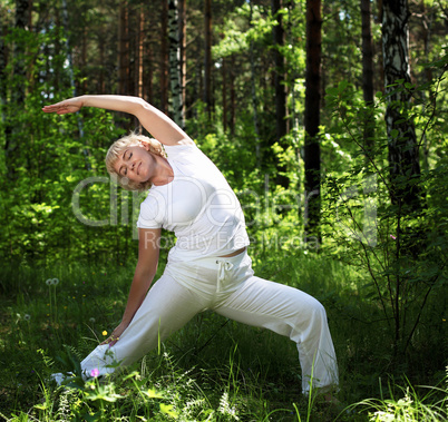 An elderly woman practices yoga