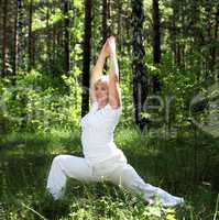 An elderly woman practices yoga