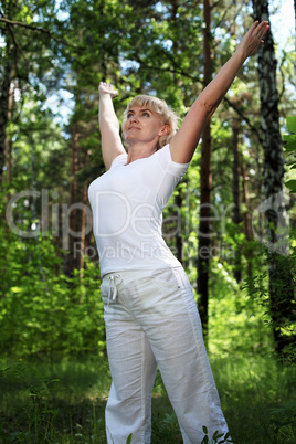 An elderly woman practices yoga