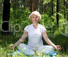 An elderly woman practices yoga