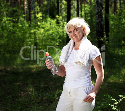 elderly woman after exercising in the forest