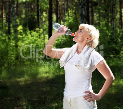 elderly woman after exercising in the forest