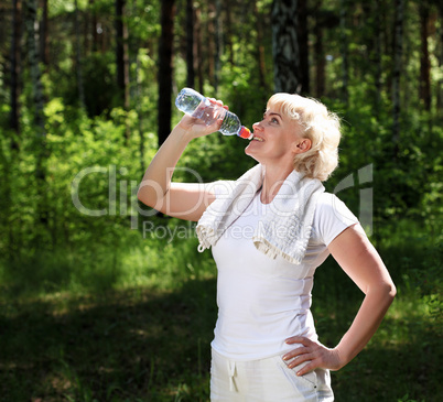 elderly woman after exercising in the forest