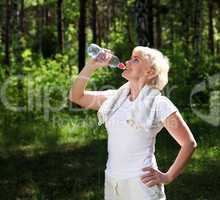 elderly woman after exercising in the forest