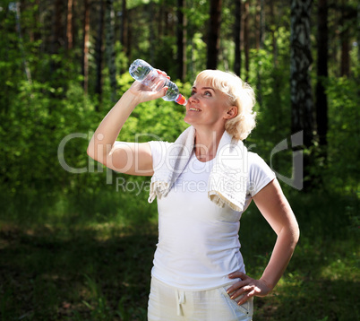 elderly woman after exercising in the forest