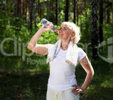 elderly woman after exercising in the forest