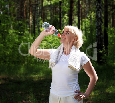 elderly woman after exercising in the forest