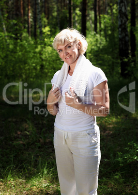 Portrait of an elderly woman in sportswear with a towel