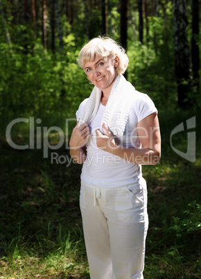 Portrait of an elderly woman in sportswear with a towel