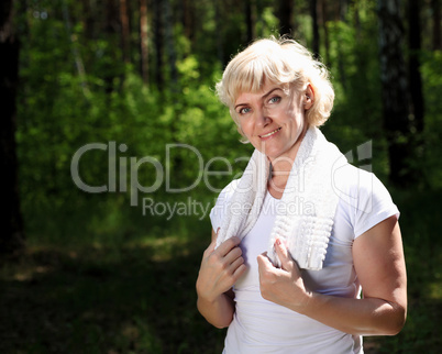 Portrait of an elderly woman in sportswear with a towel