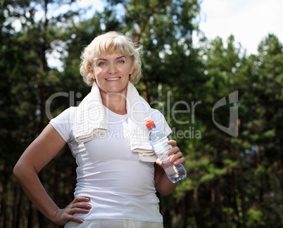 elderly woman after exercising in the forest