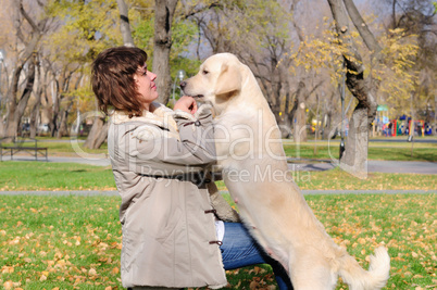 Young girl playing with dog