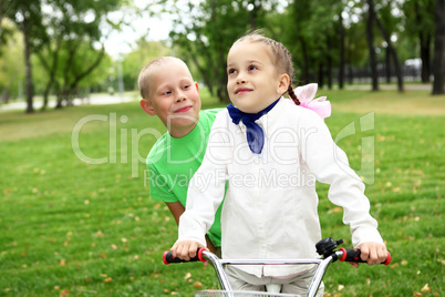 Girl on a bicycle in the green park