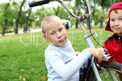 Boy on a bicycle in the green park