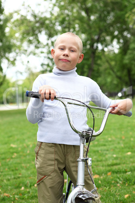 Boy on a bicycle in the green park