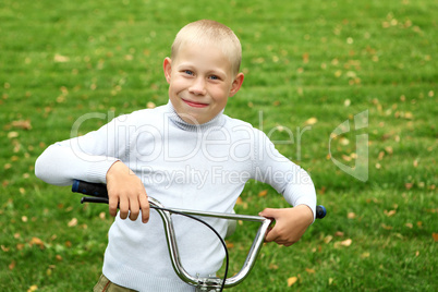 Boy on a bicycle in the green park