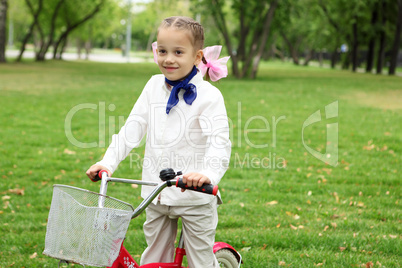 Girl on a bicycle in the green park