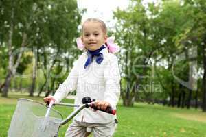 Girl on a bicycle in the green park